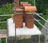Chimney pots re-seated in mortar via scaffolding to ensure a safe system of work
